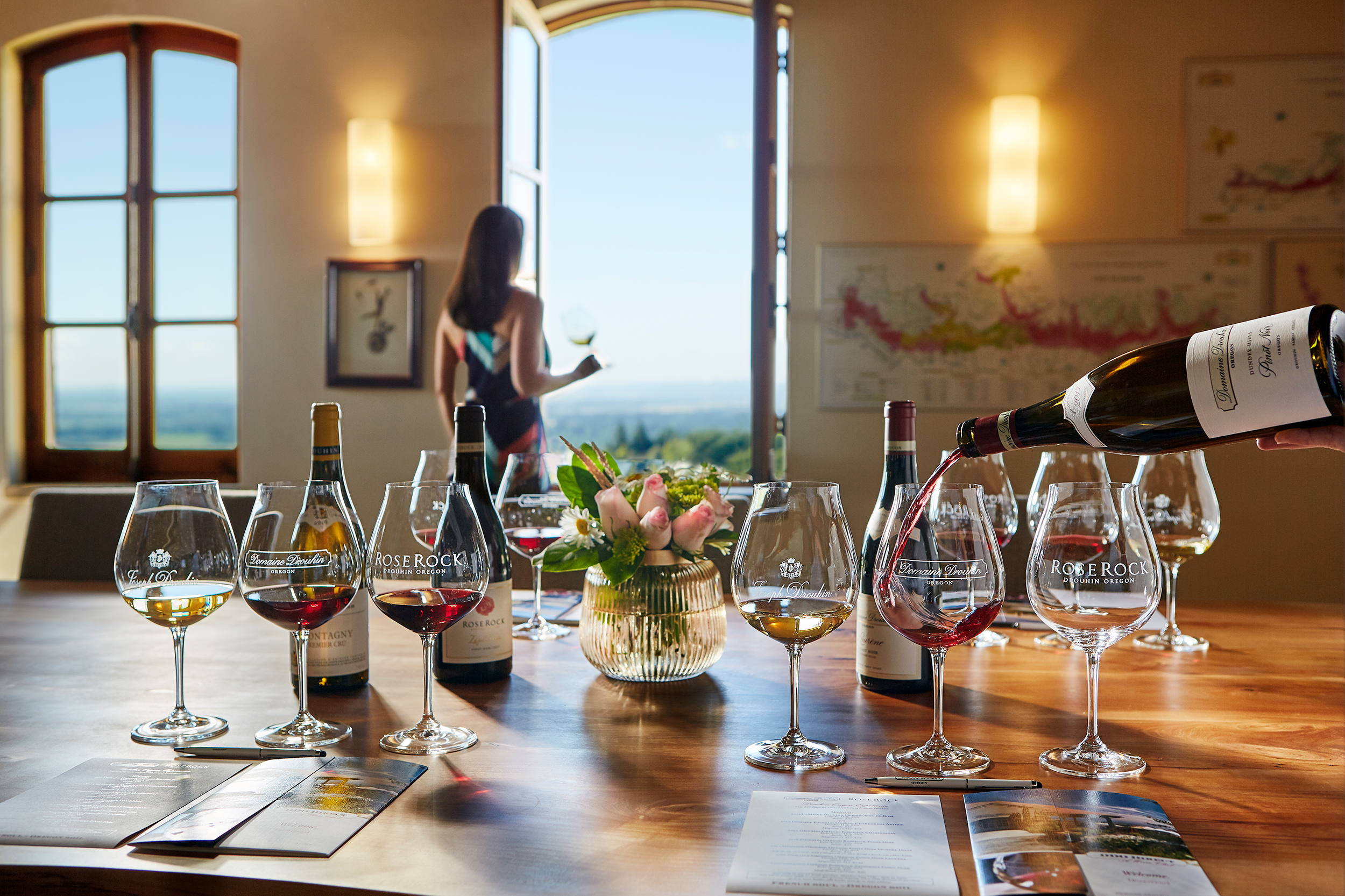 Pouring wine into a glass for a tasting flight