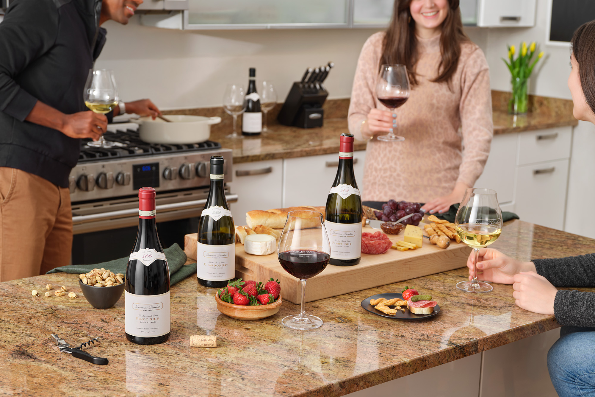 People enjoying wine and cooking food